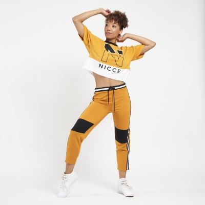 Streetwear shot of a model in a yellow NICCE tracksuit. By Nick van der Touw.