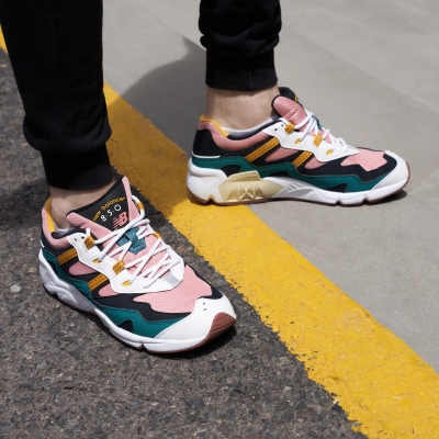 Footwear shot of colourful chunky sneakers on a yellow line. By Nick van der Touw.