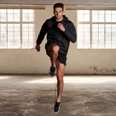 Activewear shot of a man running in an industrial space. By Nick van der Touw.