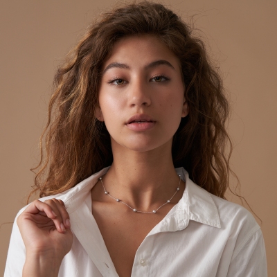 E-commerce fashion shot of a woman in a white collared shirt. By Nick van der Touw.