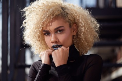 Beauty portrait of a woman with glitter makeup and a blonde afro. By Nick van der Touw.
