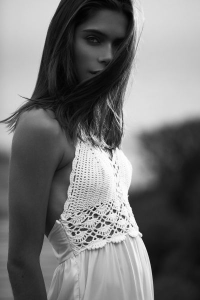 Black and white coastal fashion portrait of a woman in a knit top. By Nick van der Touw.