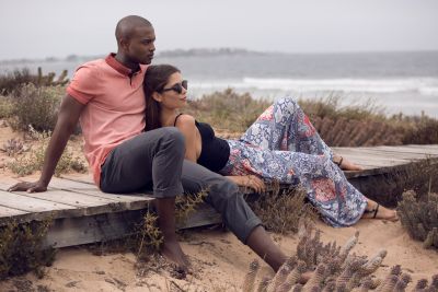 Lifestyle frame of a couple in casual wear on the coast. By Nick van der Touw.