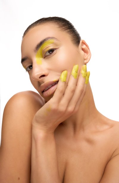 Beauty close-up of Albina with a graphic cobalt-lined lip, hands framing the face. Studio editorial by Nick van der Touw.