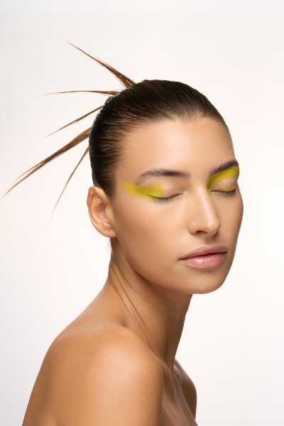 Beauty portrait of Albina in graphic yellow eye makeup. Studio editorial by Nick van der Touw.