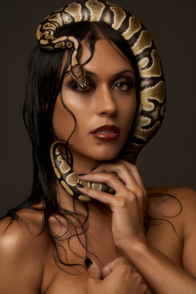 Beauty portrait of Tara Geel posed with a snake. Studio editorial by Cape Town photographer Nick van der Touw.