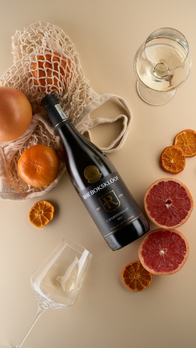 Rhebokskloof Chardonnay in a citrus flat lay. By Nick van der Touw.
