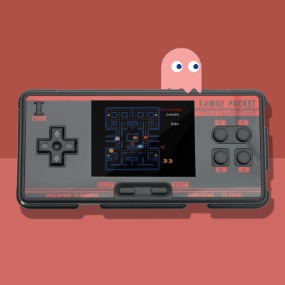 Lifestyle shot of a retro handheld game console playing an arcade game. By Nick van der Touw.