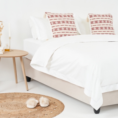 Bedroom homeware scene with white bedding and a diffuser. By Nick van der Touw.