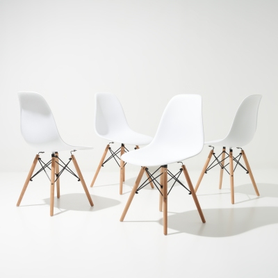 Product shot of white moulded dining chairs. By Nick van der Touw.