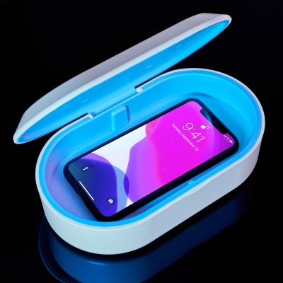 Product shot of a UV phone sanitiser with a phone inside. By Nick van der Touw.