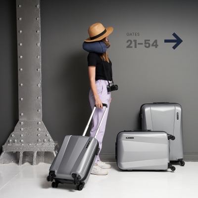 Lifestyle travel shot of a model with a suitcase. By Nick van der Touw.