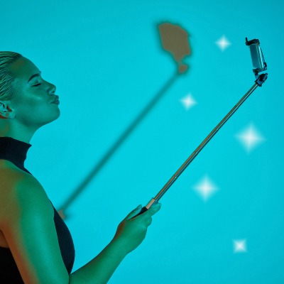 Creative beauty shot of a woman painted teal with sparkles. By Nick van der Touw.