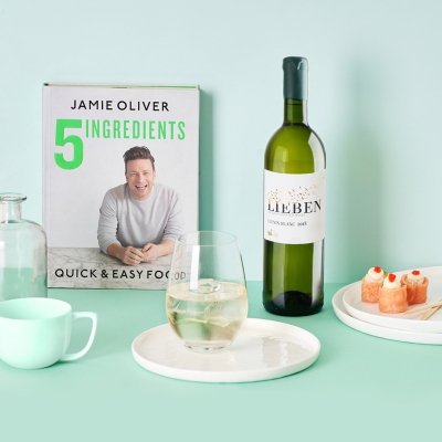 Lifestyle shot of a Jamie Oliver cookbook with wine and canapes. By Nick van der Touw.