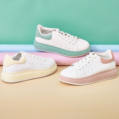 Product shot of white sneakers with mint accents. By Nick van der Touw.