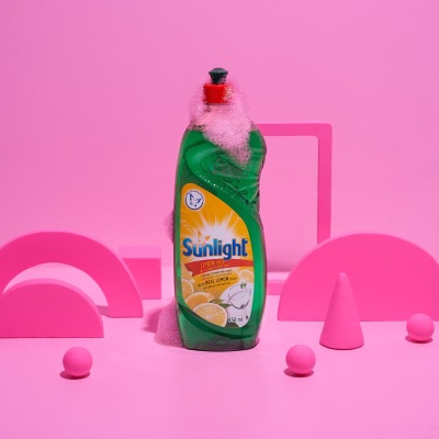 Product shot of Sunlight dishwashing liquid on pink. By Nick van der Touw.