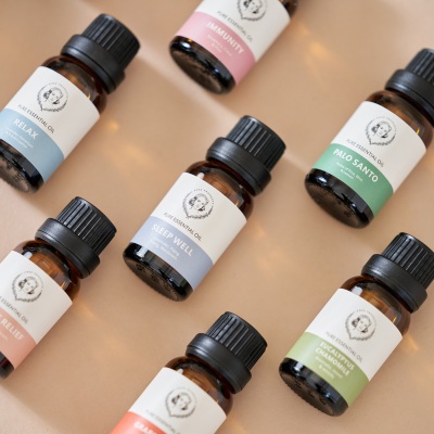 Product shot of essential oil bottles with black caps. By Nick van der Touw.