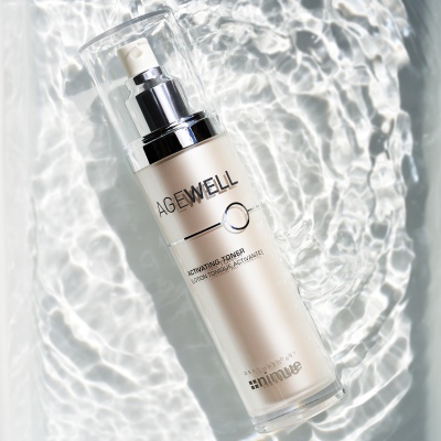 Skincare shot of an Agewell serum bottle on rippling water. By Nick van der Touw.