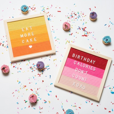 Lifestyle letter-board flat lay with cupcakes and confetti. By Nick van der Touw.