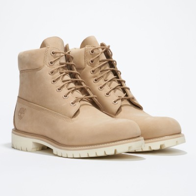 Product shot of wheat-toned work boots. By Nick van der Touw.