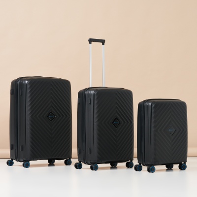 Product shot of a black hardshell suitcase set. By Nick van der Touw.