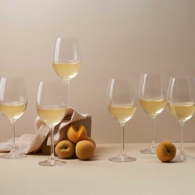 Lifestyle shot of white wine glasses with citrus. By Nick van der Touw.