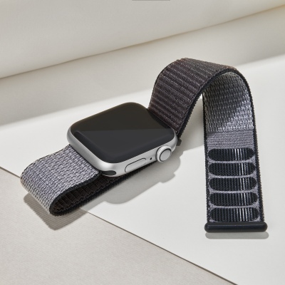 Product shot of an Apple Watch with a grey woven band. By Nick van der Touw.