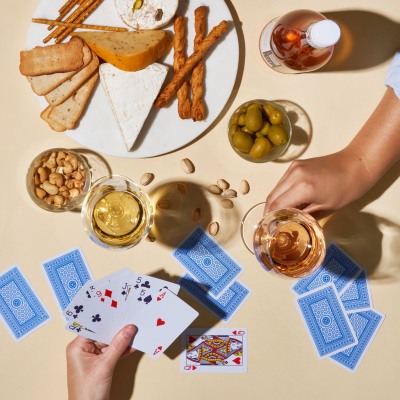 Lifestyle table scene with drinks, snacks and cards. By Nick van der Touw.