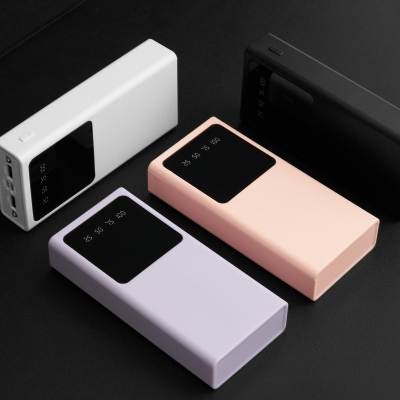 Product shot of power banks in white, pink and black. By Nick van der Touw.