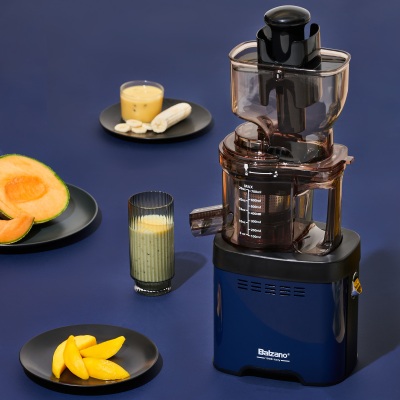 Product shot of a Balzano slow juicer with citrus on blue. By Nick van der Touw.