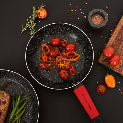 Food shot of cherry tomatoes and chillies in a pan. By Nick van der Touw.