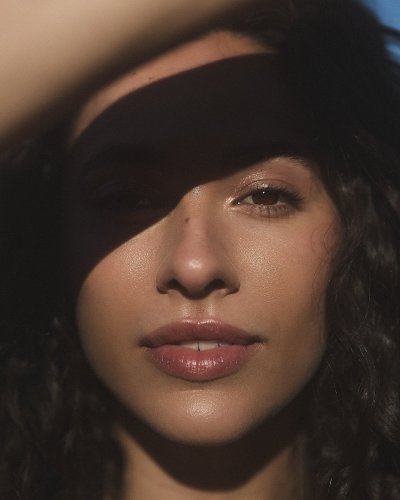 Beauty editorial of Zoe with patterned shadow falling across the face. By Nick van der Touw.