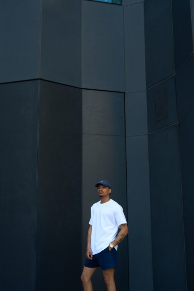 Muti Summer 2024 campaign frame set against industrial panels. By Nick van der Touw.