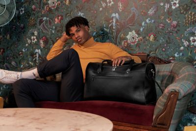 Woodstock Leather 2021 campaign frame against vintage floral wallpaper. By Nick van der Touw.