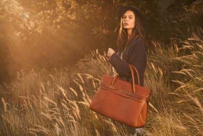 Woodstock Leather 2020 campaign frame in tall outdoor grasses. By Nick van der Touw.