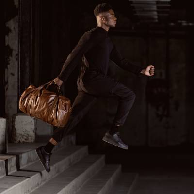 Woodstock Leather 2020 campaign motion frame mid jump. Fashion photography by Nick van der Touw.