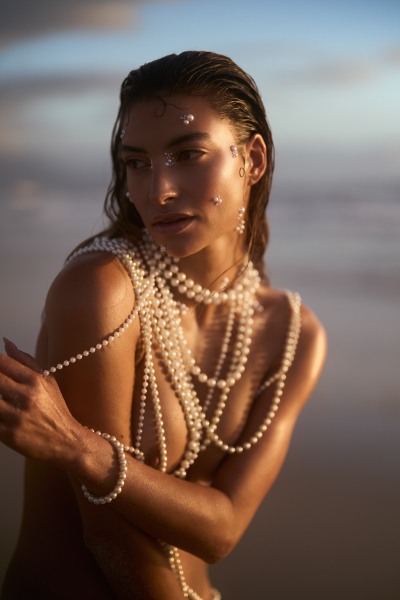 Sunset editorial of Albina styled with pearls on the coast. Coastal photography by Nick van der Touw.
