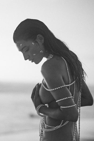 Editorial profile portrait of Albina styled with pearls. Coastal photography by Nick van der Touw.